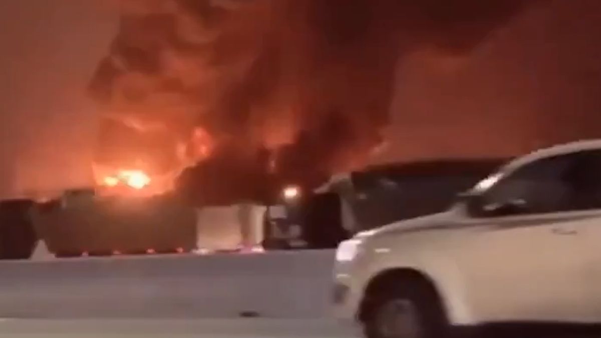 Incendiu puternic în timpul nopții, cu flăcări uriașe și coloane dense de fum negru, surprins de pe o șosea din Arabia Saudită.